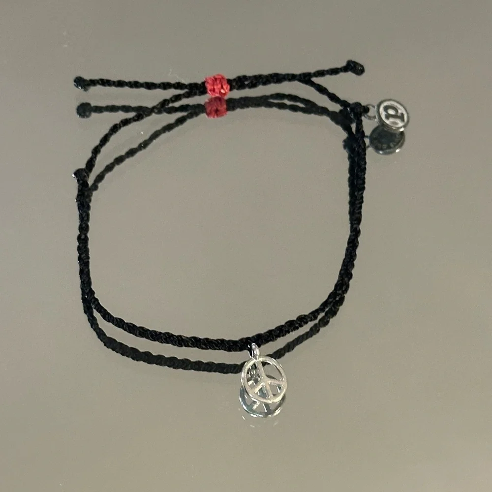 Pura Vida. Black Braided Bracelet with Silver Peace Charm and Red Accent